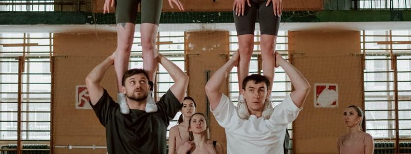Group of people practicing synchronized movement in a bright hall